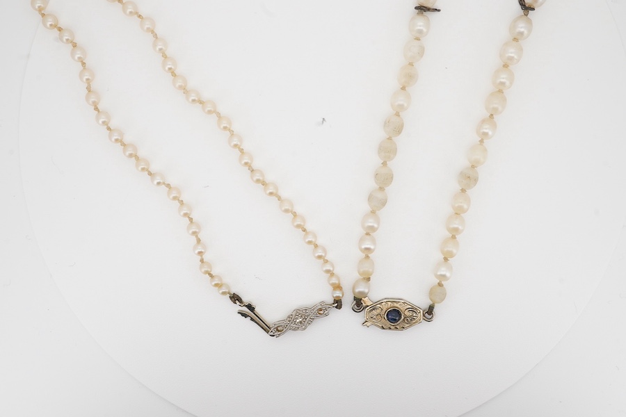 Two single strand cultured pearl necklaces, one graduated with 18ct, plat and three stone diamond set clasp, 60cm, the other with cabochon sapphire set unmarked clasp (a.f.). Condition - poor to fair.